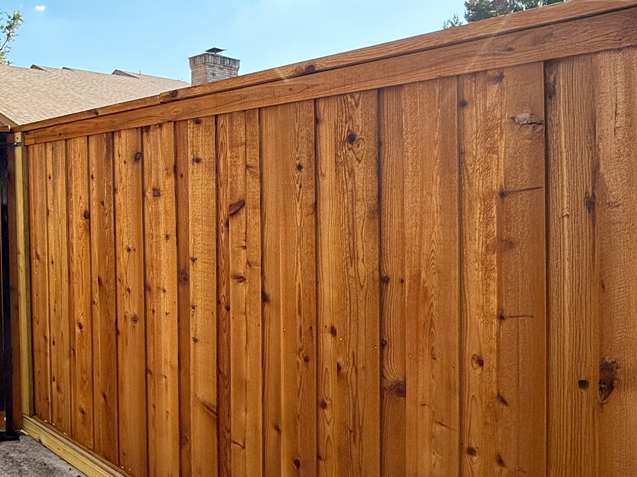 Wood stained fence installed by G's Fence Company
