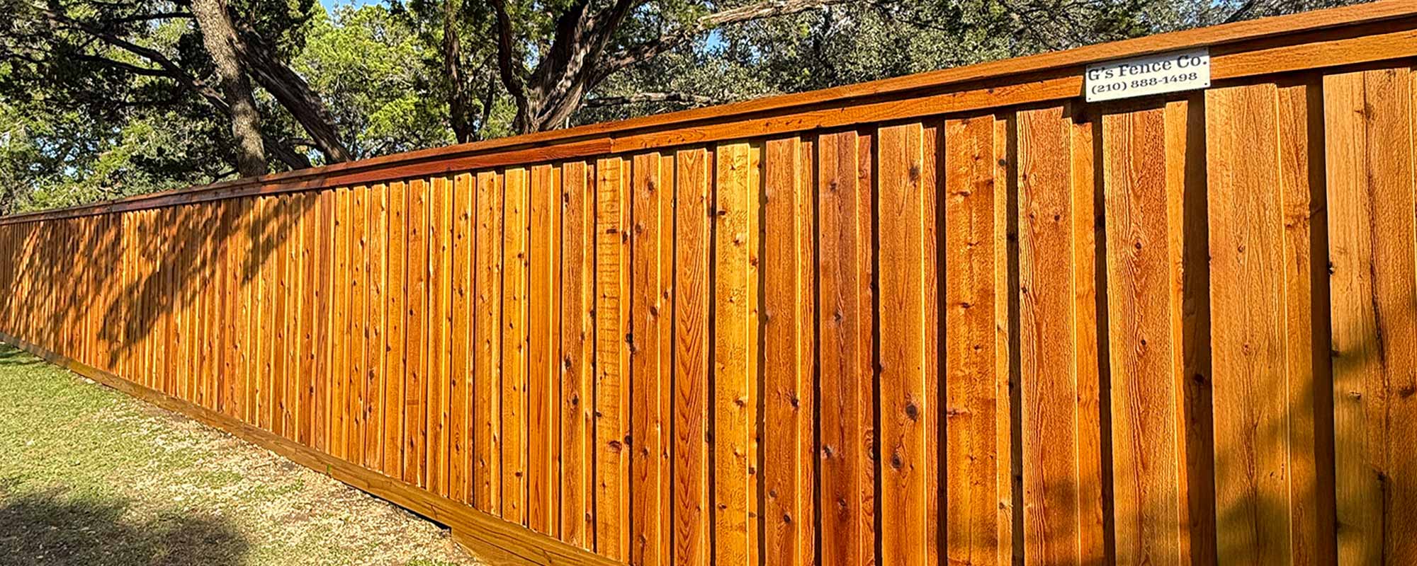 stained wood fence board on board with cap & trim