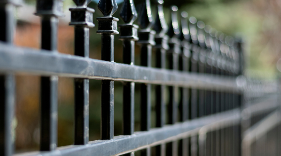 focused picture of a black iron fence