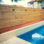 Wooden privacy fence installed by G's Fence Company in San Antonio, TX, surrounding a modern pool area